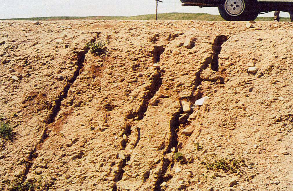 Soil erosion caused by water runoff on a sloped surface