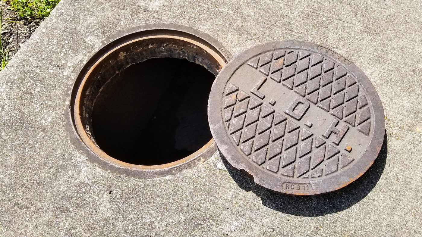 Open access cover on concrete surface