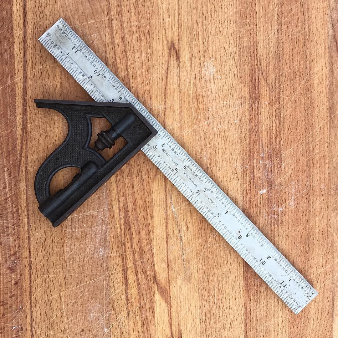 Combination square on wooden surface