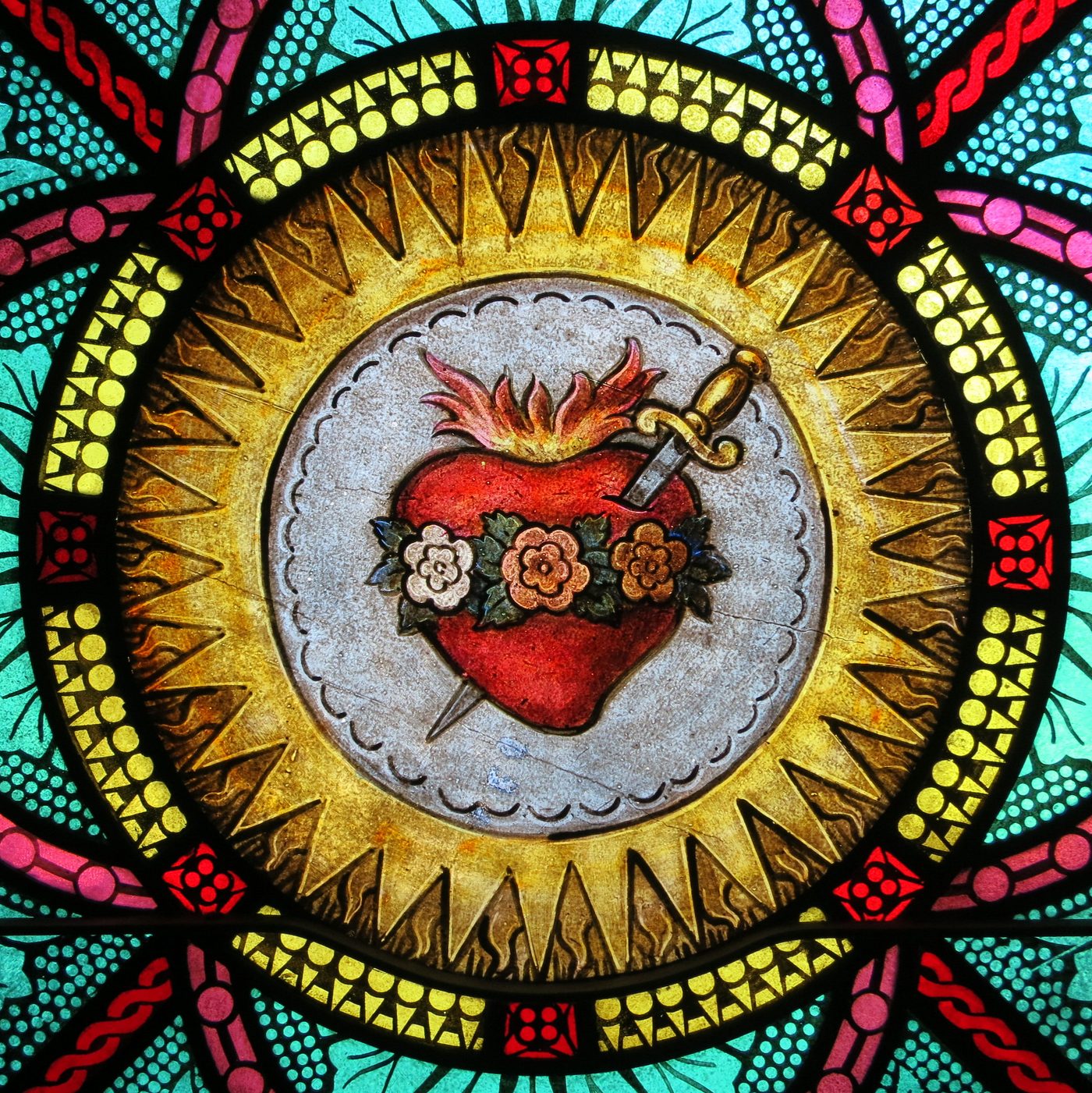 Decorative stained glass with heart and sword design