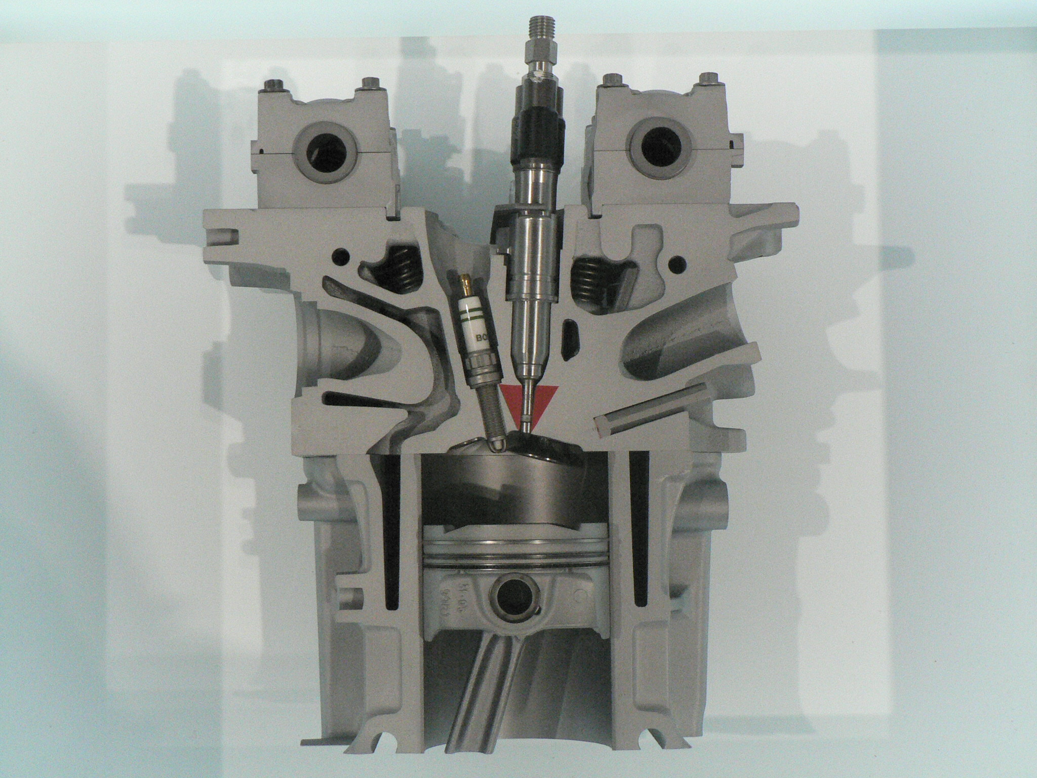 Direct fuel injector in engine cross-section