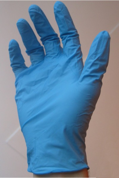 blue disposable nitrile glove on hand