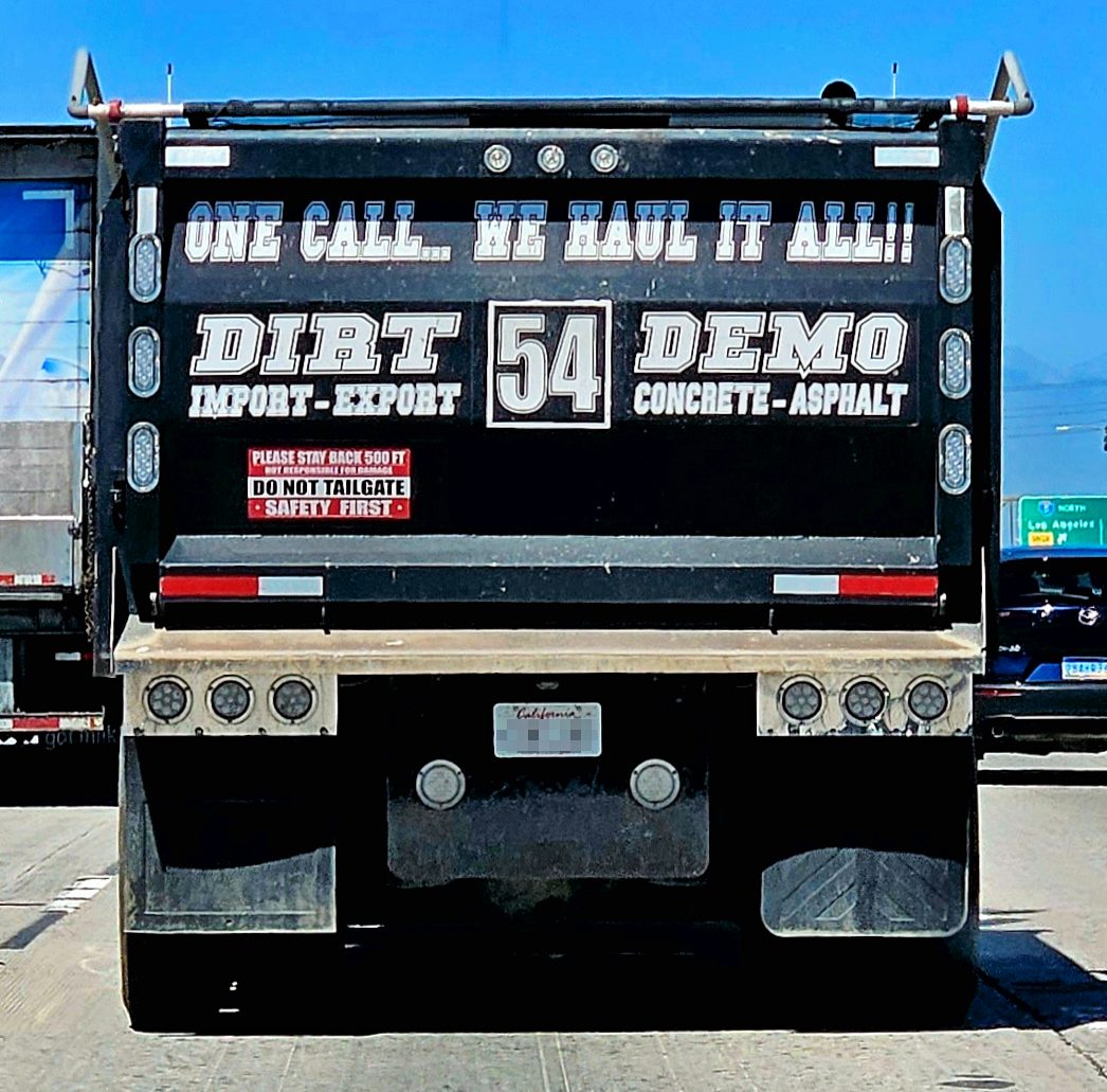 Rear view of a dump truck on highway