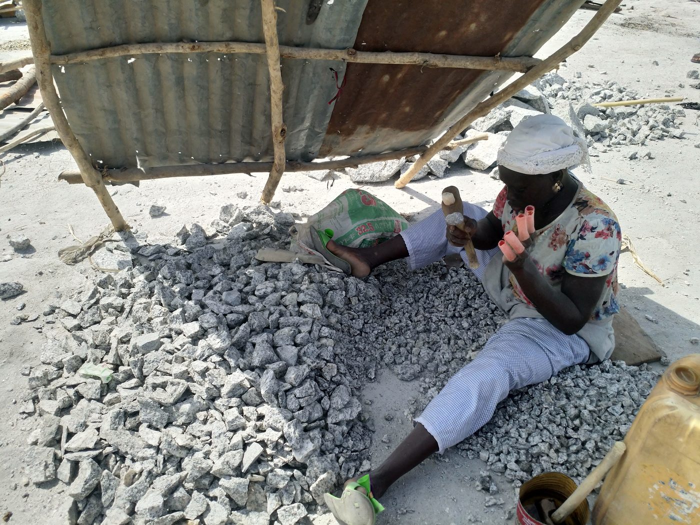 Person sorting granite stones for construction