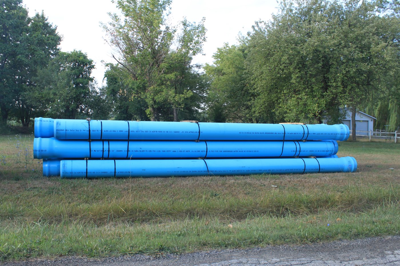 Stacked blue HDPE pipes outdoors