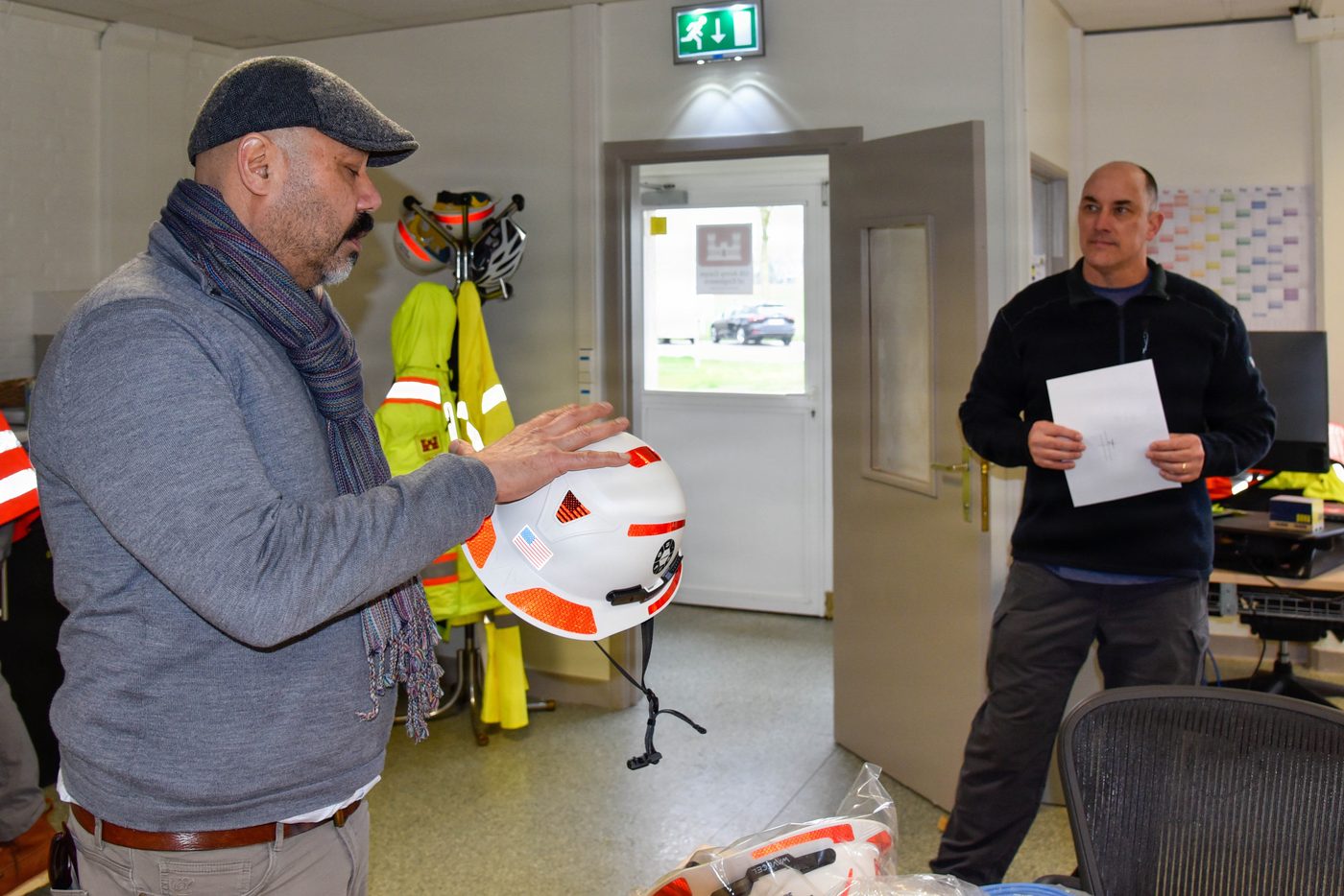 Man holding a safety helmet indoors