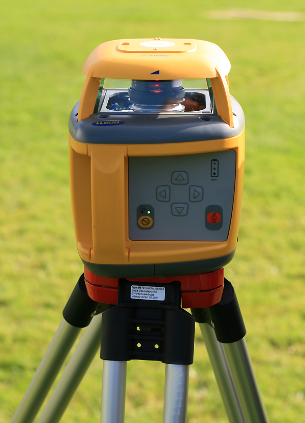 Rotary laser level on tripod outdoors