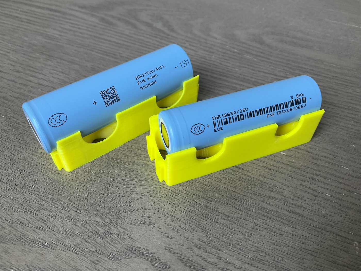 Two cylindrical lithium-ion cells in holders