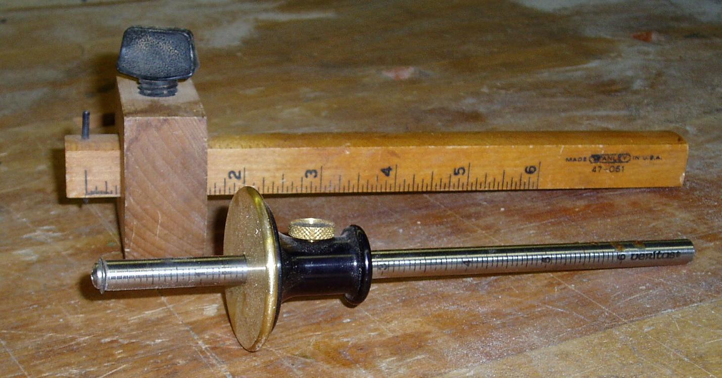 Two types of marking gauges on a wooden surface