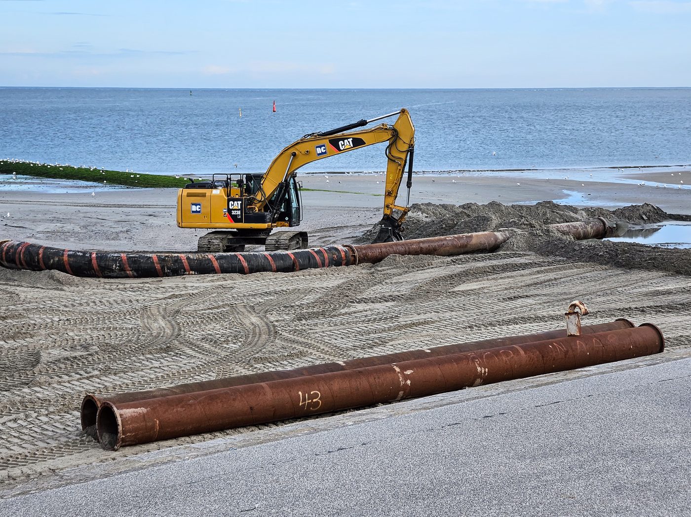 Rusty metal pipes on a beach construction site