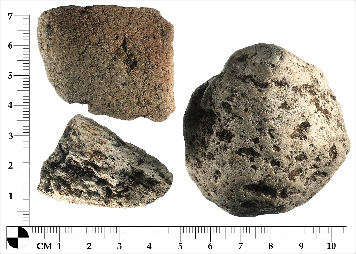 Three natural stones with measurement scale