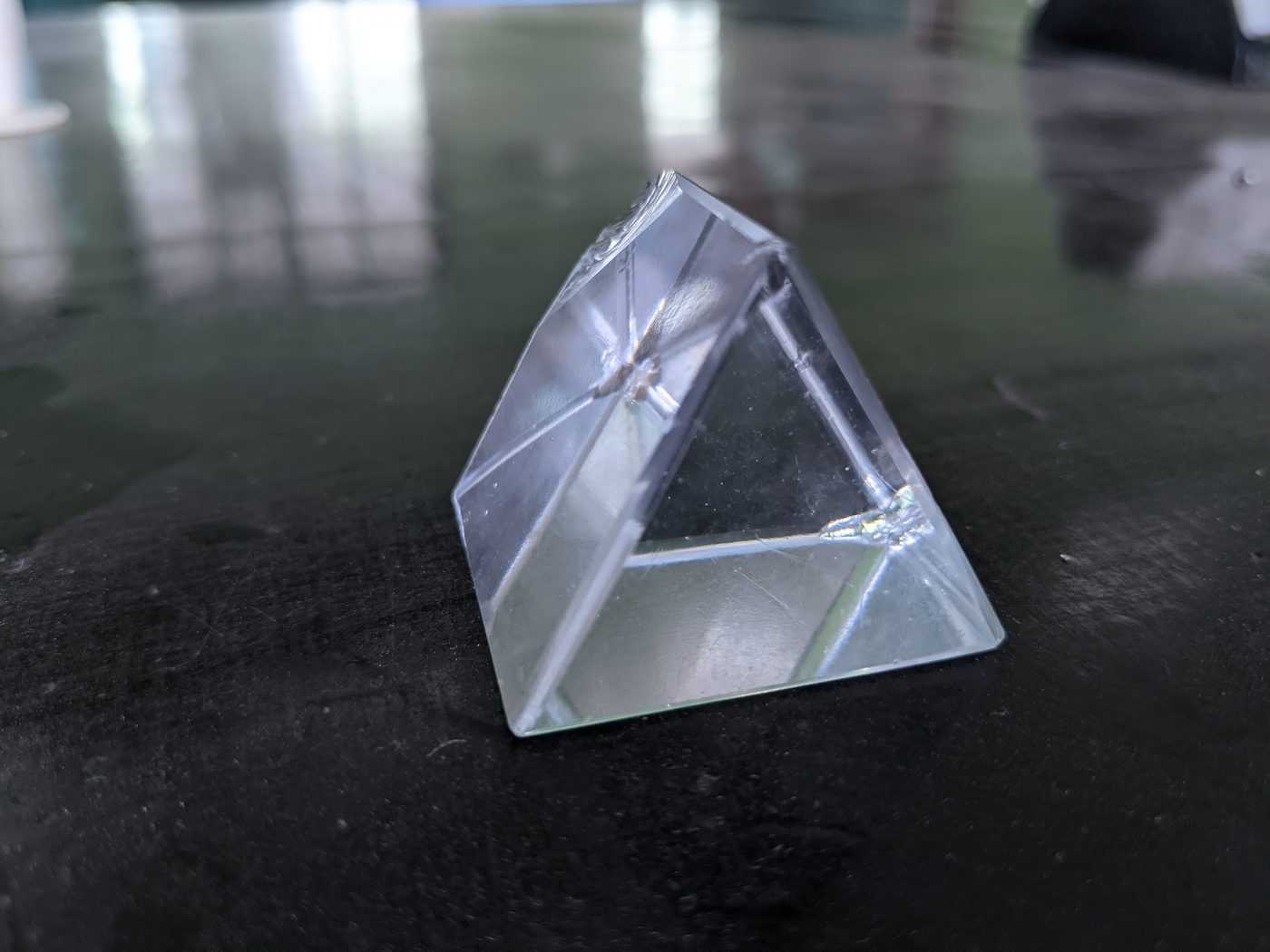 Clear plastic oblique prism on table