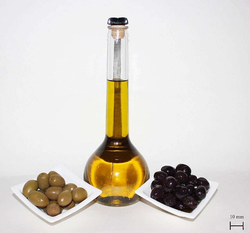Bottle of olive oil with green and black olives