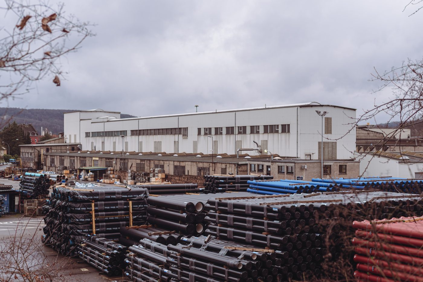 Stacks of pvc pipes outside a factory