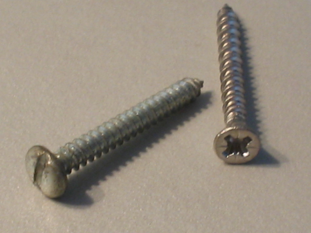 Two self-tapping screws on a surface