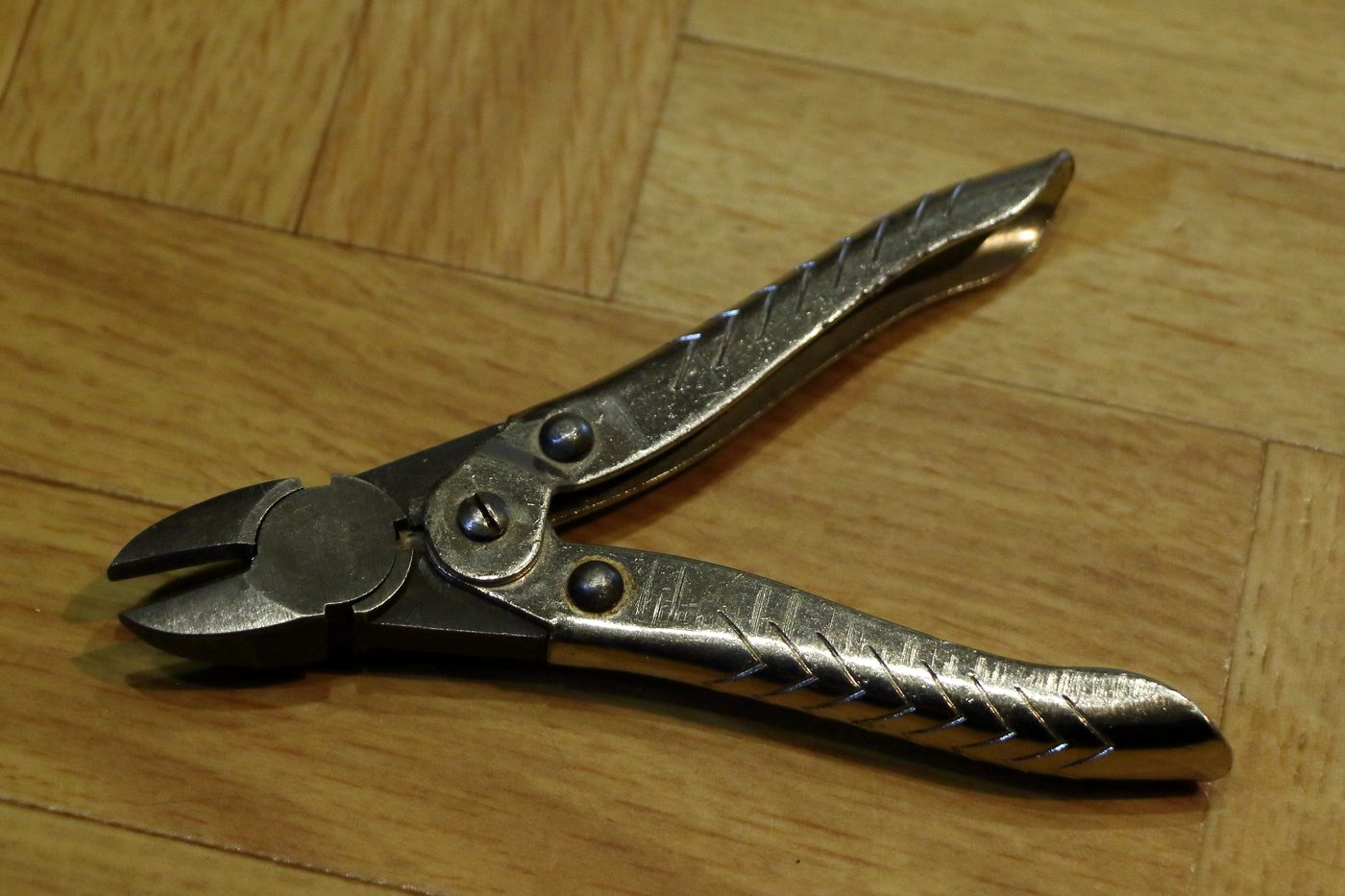 Metal side cutting plier on wooden surface