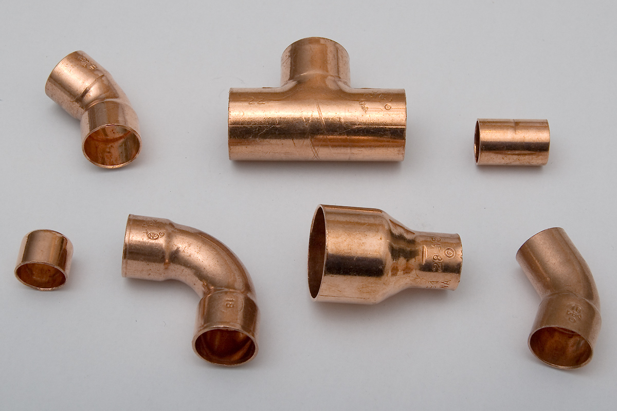 Copper plumbing tee fitting in center