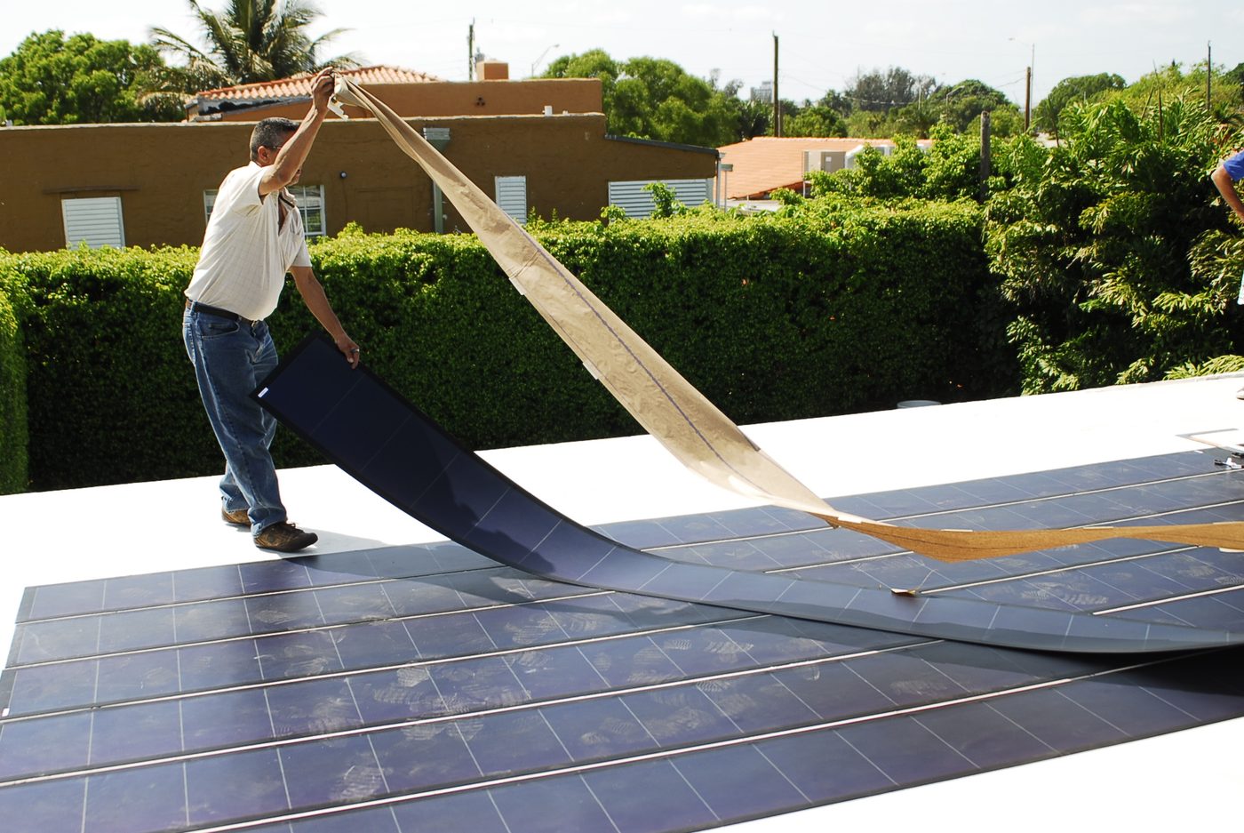 Flexible thin-film solar panels being installed