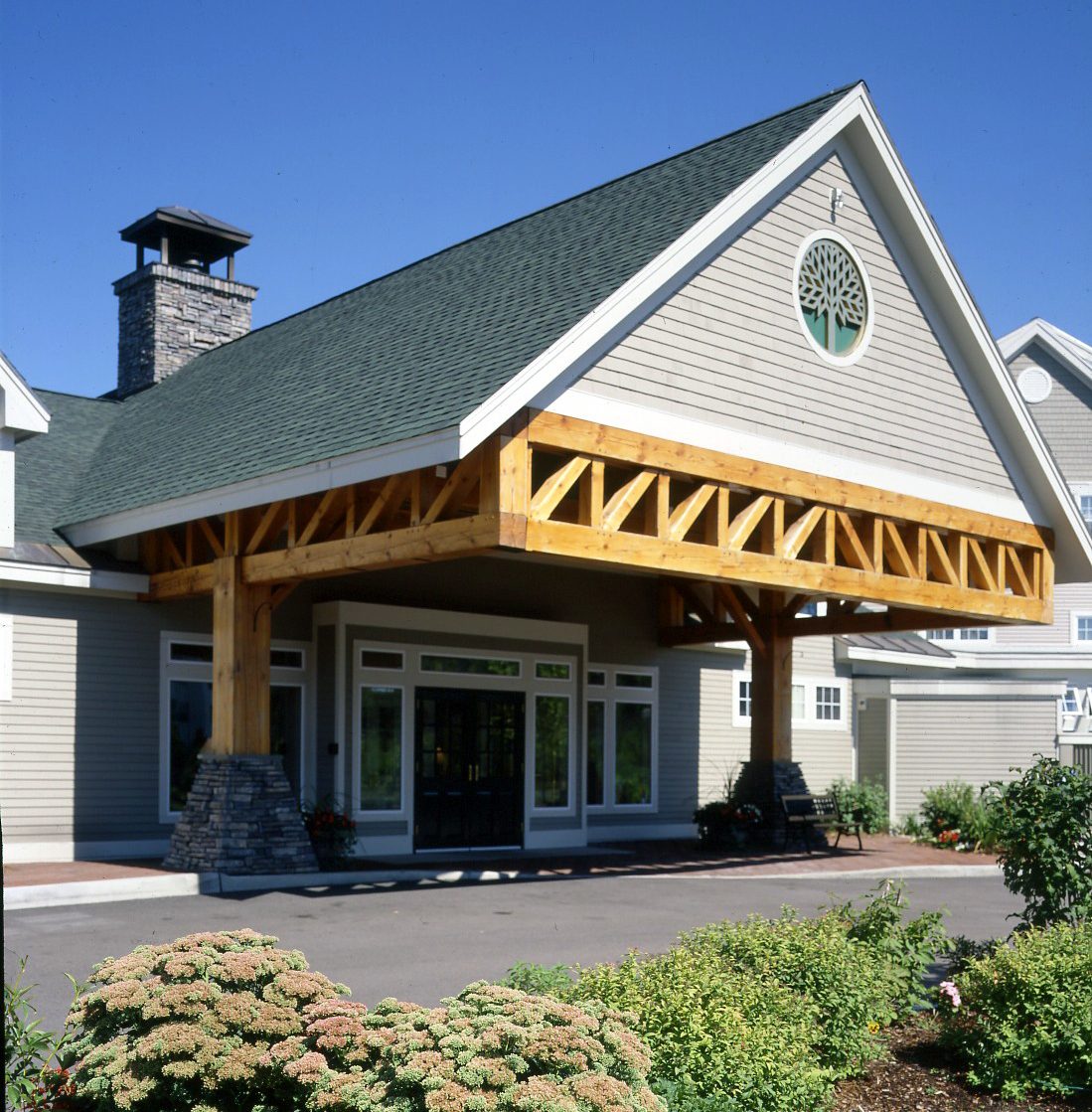 timber beams supporting building entrance roof